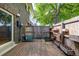 Backyard of a brick house with wooden patio, privacy fence with planter boxes, and access to the house at 8023 Wolff St # C, Westminster, CO 80031