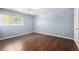 Bedroom with hardwood floors and a large window, letting in natural light at 8023 Wolff St # C, Westminster, CO 80031