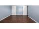 Spacious bedroom features wood floors and two white doors to closets or bathroom at 8023 Wolff St # C, Westminster, CO 80031