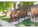 Inviting townhouse entrance featuring a fenced yard, well-maintained landscaping, and covered porch at 8023 Wolff St # C, Westminster, CO 80031