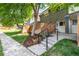 Lovely townhouse with a brick exterior, wooden fence, landscaped front yard, and covered entry at 8023 Wolff St # C, Westminster, CO 80031