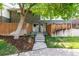 Charming townhouse featuring a brick facade, fenced-in front yard, and landscaped entrance at 8023 Wolff St # C, Westminster, CO 80031