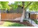 Charming townhouse featuring a brick facade, fenced-in front yard, and landscaped entrance at 8023 Wolff St # C, Westminster, CO 80031