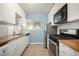 Modern kitchen featuring stainless steel appliances, tile backsplash, and sleek countertops at 8023 Wolff St # C, Westminster, CO 80031