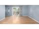 Spacious living area featuring beautiful hardwood floors, natural light, and sliding glass door at 8023 Wolff St # C, Westminster, CO 80031