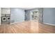 Open-concept living area with hardwood floors, sliding door to patio, and adjacent laundry area at 8023 Wolff St # C, Westminster, CO 80031