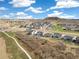 Expansive view of a Primary-planned community with green spaces, walking paths, and mountain views at 863 Edenborn Pl, Castle Rock, CO 80104