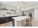 Basement bar area with seating, custom cabinets, and floating shelves at 863 Edenborn Pl, Castle Rock, CO 80104