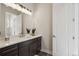 Contemporary bathroom with a dark wood vanity, white countertop, and modern lighting at 863 Edenborn Pl, Castle Rock, CO 80104