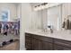 Bathroom with dual vanities, and access to a large walk in closet with plenty of storage space at 863 Edenborn Pl, Castle Rock, CO 80104