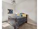 Stylish bedroom with neutral walls, modern light fixture, and playful space-themed decor at 863 Edenborn Pl, Castle Rock, CO 80104