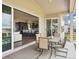 Covered patio with outdoor dining set, sliding glass door, and backyard views at 863 Edenborn Pl, Castle Rock, CO 80104