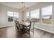Bright dining area featuring a rustic wooden table, contemporary light fixture, and large windows at 863 Edenborn Pl, Castle Rock, CO 80104