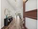 Inviting home entryway with wood floors, stylish console table, and decorative accents, offering a glimpse of the view beyond at 863 Edenborn Pl, Castle Rock, CO 80104