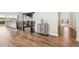 Open hallway leading to living spaces, featuring hardwood floors and neutral decor with a glimpse of the staircase at 863 Edenborn Pl, Castle Rock, CO 80104