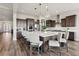Large kitchen with an island, breakfast bar, stainless steel appliances, and stylish pendant lighting at 863 Edenborn Pl, Castle Rock, CO 80104