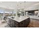 Open-concept kitchen with a center island, stainless appliances, and a connected dining area at 863 Edenborn Pl, Castle Rock, CO 80104