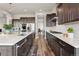 Well-lit kitchen with stainless steel appliances, a spacious island, and dark wood cabinetry at 863 Edenborn Pl, Castle Rock, CO 80104