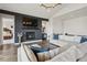 Modern living room with fireplace, TV, hardwood floors, and an elegant sectional couch at 863 Edenborn Pl, Castle Rock, CO 80104