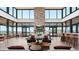 Spacious lounge featuring floor-to-ceiling windows, stone fireplace and stylish seating at 863 Edenborn Pl, Castle Rock, CO 80104