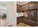 Mudroom with wood cabinets, bench seating, and hooks for coats and jackets at 863 Edenborn Pl, Castle Rock, CO 80104