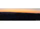 Backyard view featuring a fence, some vegetation, and a beautiful sunset at 863 Edenborn Pl, Castle Rock, CO 80104
