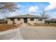 Traditional brick home with a well-kept front lawn and inviting walkway on a sunny day at 6690 S Sheridan Blvd, Littleton, CO 80123