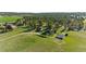 Aerial view showcases the home, barn, outbuildings, and lush acreage, all surrounded by tall pine trees at 10522 Bayou Gulch Rd, Parker, CO 80134