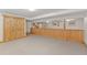 Large carpeted basement with storage and wood accents at 10522 Bayou Gulch Rd, Parker, CO 80134