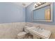 Elegant powder room with marble accents, stylish fixtures, and ample lighting at 10522 Bayou Gulch Rd, Parker, CO 80134