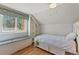 Bright bedroom featuring a window seat, built-in shelving, and hardwood floors at 10522 Bayou Gulch Rd, Parker, CO 80134