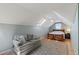 Cozy bedroom with a seating area, skylight, and hardwood floors at 10522 Bayou Gulch Rd, Parker, CO 80134