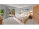 Bright bedroom with private deck access, plush carpet, and ample natural light at 10522 Bayou Gulch Rd, Parker, CO 80134