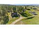 Aerial view of a charming brick home featuring a well-manicured yard and quaint outbuildings at 10522 Bayou Gulch Rd, Parker, CO 80134