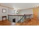 Hallway with hardwood floors, decorative iron railing and a window seat at 10522 Bayou Gulch Rd, Parker, CO 80134