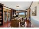 Sophisticated home office featuring custom built-ins, hardwood floors, and a scenic window view at 10522 Bayou Gulch Rd, Parker, CO 80134