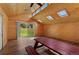 Bright interior space with wood paneling, skylights, laminate flooring, and sliding glass doors to the backyard at 10522 Bayou Gulch Rd, Parker, CO 80134