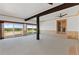 Open-concept living room features scenic views, beamed ceilings, and wood paneling at 10522 Bayou Gulch Rd, Parker, CO 80134