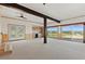 Spacious living room with large windows, beamed ceilings, and convenient kitchenette at 10522 Bayou Gulch Rd, Parker, CO 80134