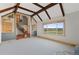 Spacious living room with exposed beams, large window view, and open layout at 10522 Bayou Gulch Rd, Parker, CO 80134