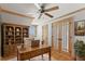 Charming office with a wooden desk, built-in bookshelves, and a ceiling fan at 10522 Bayou Gulch Rd, Parker, CO 80134