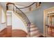 Elegant staircase with wrought iron railings and hardwood steps at 10522 Bayou Gulch Rd, Parker, CO 80134