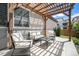 Outdoor patio with pergola, ample seating, and neutral tones, ideal for entertaining or enjoying a quiet evening at 9603 Dunning Cir, Highlands Ranch, CO 80126