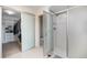 Modern bathroom featuring a glass-enclosed shower, white tiling, and a convenient walk-in closet at 9603 Dunning Cir, Highlands Ranch, CO 80126