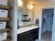 Modern bathroom features a double sink vanity, floating shelves, and a walk-in closet at 9603 Dunning Cir, Highlands Ranch, CO 80126