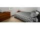 Comfortable bedroom with patterned comforter and classic wooden dresser at 9603 Dunning Cir, Highlands Ranch, CO 80126
