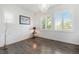 Bright and airy bedroom with laminate floors, shuttered windows, and a modern chandelier at 9603 Dunning Cir, Highlands Ranch, CO 80126