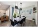 Bright dining room with modern lighting, sleek black chairs, and large windows showcasing the outdoor view at 9603 Dunning Cir, Highlands Ranch, CO 80126