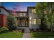 Inviting two-story home featuring a well-manicured lawn and charming front porch, set against a colorful dusk sky at 9603 Dunning Cir, Highlands Ranch, CO 80126