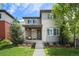 Charming two-story home featuring landscaped front yard, gray siding, and a welcoming porch perfect for relaxing at 9603 Dunning Cir, Highlands Ranch, CO 80126
